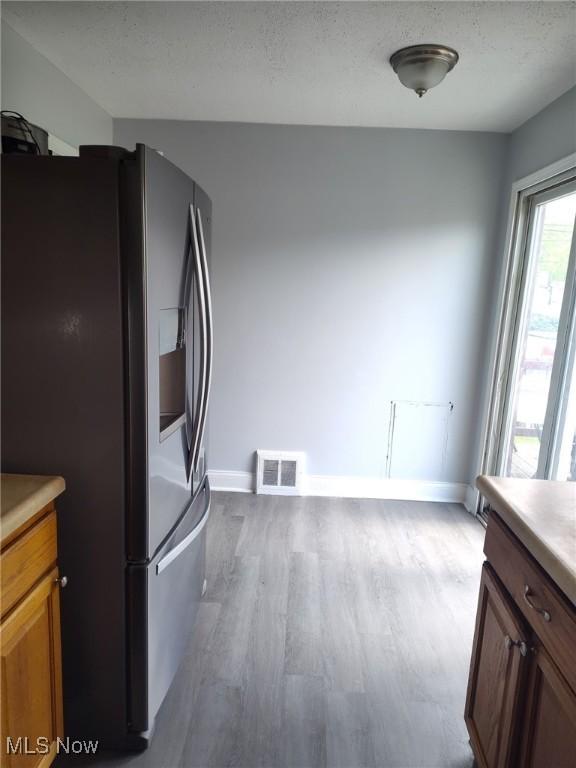 13112 Shady Oak Blvd, Garfield Heights, OH 44125 - kitchen featuring stainless steel fridge with ice dispenser, wood finished floors, and light countertops