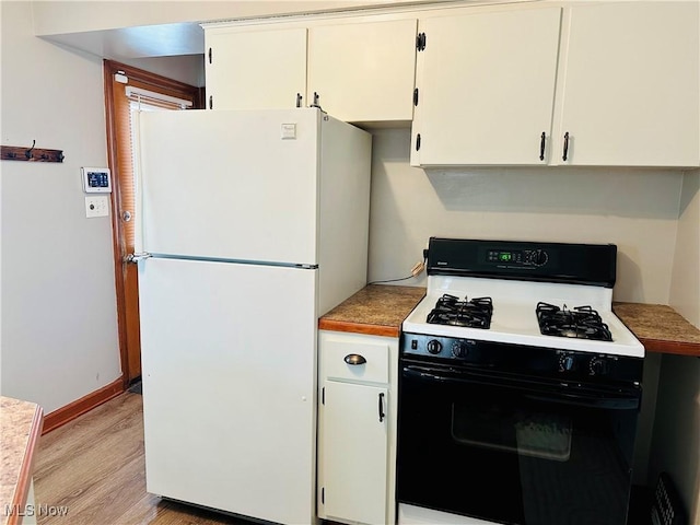 788 E Archwood Ave, Akron, OH 44306 - kitchen featuring freestanding refrigerator, range with gas cooktop, light wood-style floors, white cabinetry, and light countertops