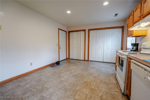 412 SW Weber Ave, Strasburg, OH 44680 - kitchen with white appliances, under cabinet range hood, light countertops, brown cabinets, and recessed lighting