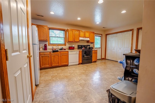412 SW Weber Ave, Strasburg, OH 44680 - kitchen with white appliances, under cabinet range hood, plenty of natural light, light countertops, and recessed lighting