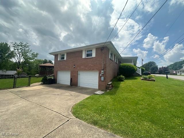 188 Court St, Follansbee, WV 26037 - view of home's exterior featuring brick siding, a garage, and concrete driveway