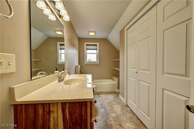 85551 Beagle Club Rd, Scio, OH 43988 - bathroom with vanity, vaulted ceiling, a tub to relax in, stone finish floors, and a closet