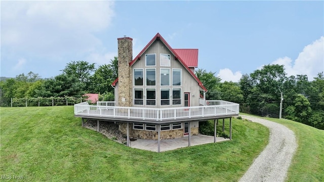 85551 Beagle Club Rd, Scio, OH 43988 - back of property featuring a deck, a chimney, a lawn, and stone siding