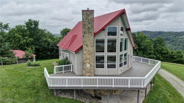 85551 Beagle Club Rd, Scio, OH 43988 - rear view of property featuring a wooden deck, a yard, a metal roof, and a chimney