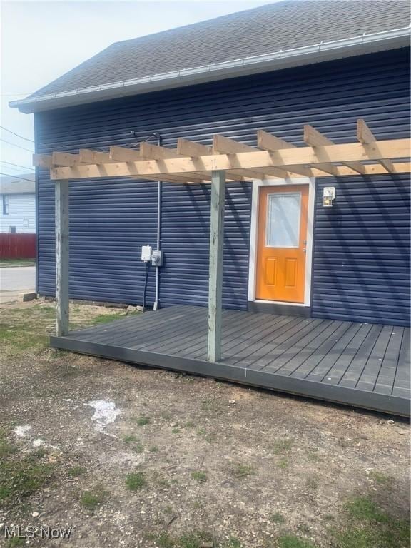 982 Day St, Conneaut, OH 44030 - view of side of home with a pergola, a wooden deck, and a shingled roof