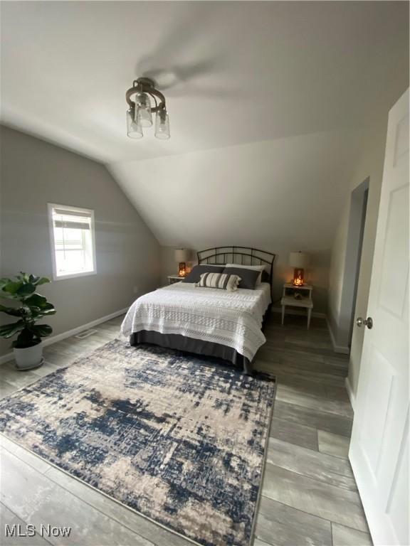 982 Day St, Conneaut, OH 44030 - bedroom with lofted ceiling and wood finished floors