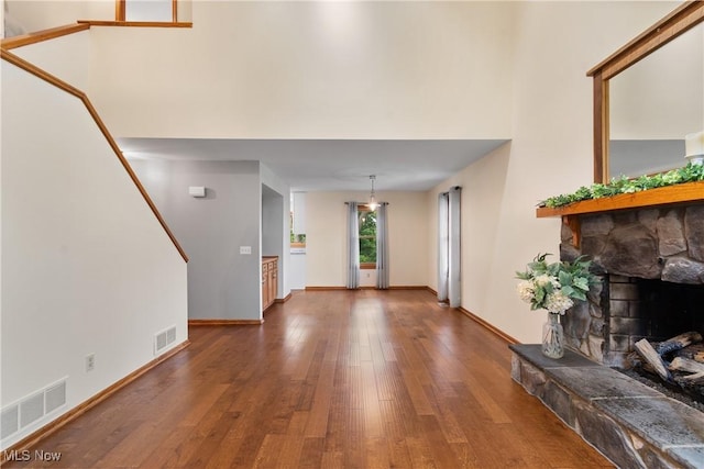 11095 Jan Cir NW, Uniontown, OH 44685 - living room featuring wood finished floors, a stone fireplace, and a high ceiling