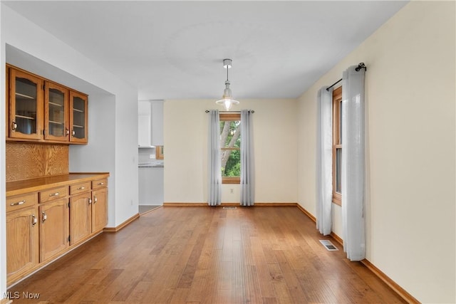 11095 Jan Cir NW, Uniontown, OH 44685 - unfurnished dining area with light wood finished floors and baseboards
