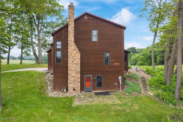 11095 Jan Cir NW, Uniontown, OH 44685 - view of property exterior with a chimney and a yard