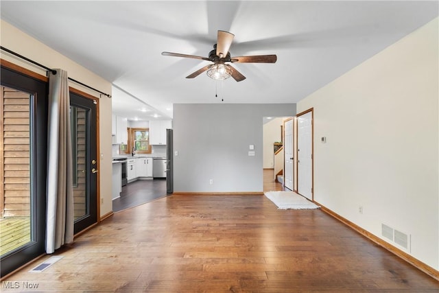 11095 Jan Cir NW, Uniontown, OH 44685 - unfurnished living room with a ceiling fan and wood-type flooring