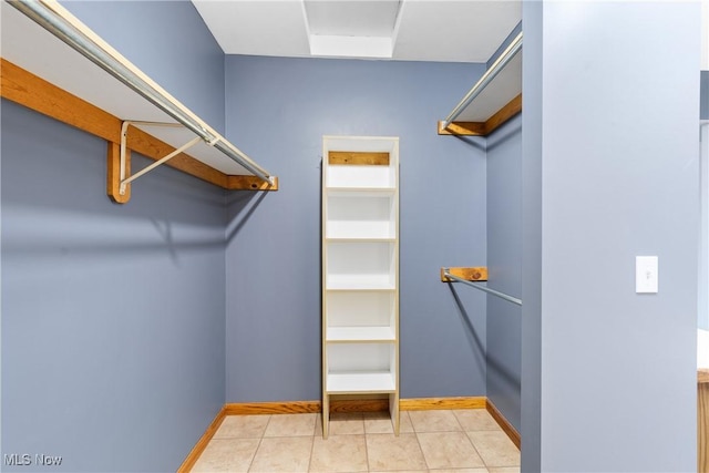 11095 Jan Cir NW, Uniontown, OH 44685 - walk in closet featuring light tile patterned floors