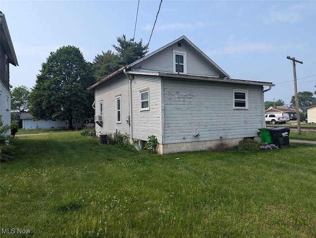 143 2nd St SE, Strasburg, OH 44680 - view of side of home with a yard and a cooling unit