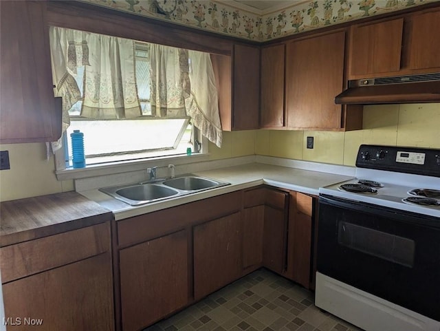 143 2nd St SE, Strasburg, OH 44680 - kitchen with range with electric stovetop, under cabinet range hood, and light countertops