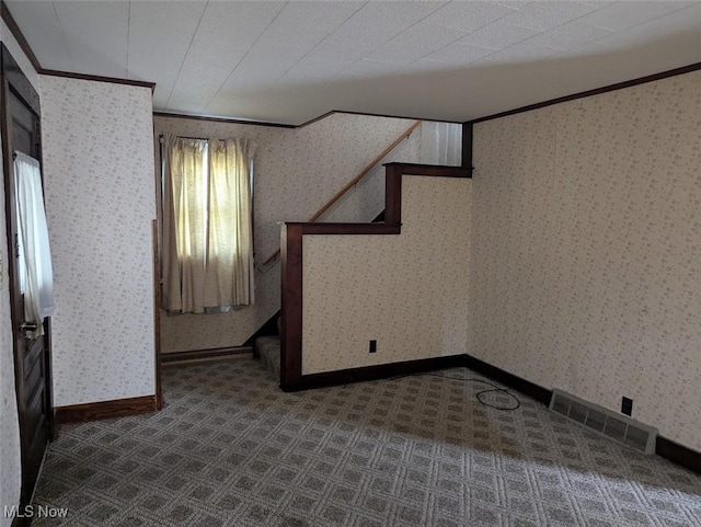 143 2nd St SE, Strasburg, OH 44680 - below grade area featuring crown molding, stairs, dark carpet, and wallpapered walls