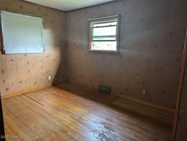 143 2nd St SE, Strasburg, OH 44680 - spare room with wood-type flooring and baseboards