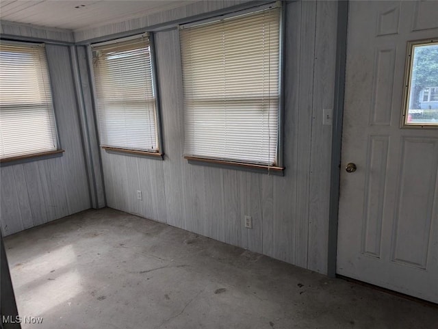 143 2nd St SE, Strasburg, OH 44680 - foyer entrance with concrete flooring and wood walls