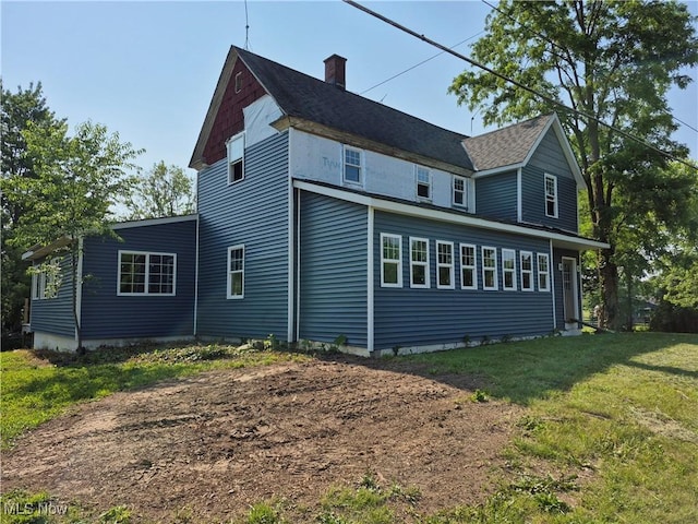7810 Avon Lake Rd, Lodi, OH 44254 - view of property exterior featuring a lawn and a chimney