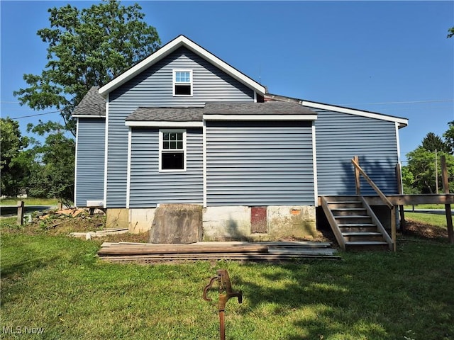 7810 Avon Lake Rd, Lodi, OH 44254 - back of property with a lawn and a shingled roof