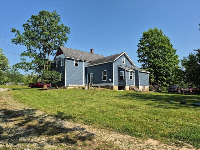 7810 Avon Lake Rd, Lodi, OH 44254 - view of home's exterior featuring a lawn and a chimney