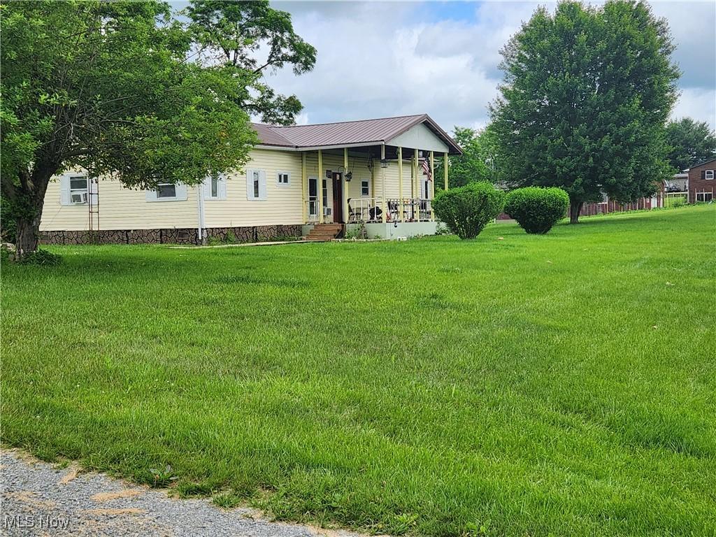 751 State Route 83, Beverly, OH 43728 - view of front of property with a porch, a front lawn, and a metal roof