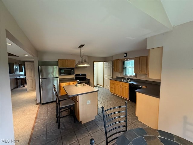 2484 Township Road 262, Bergholz, OH 43908 - kitchen with black appliances, a center island with sink, dark countertops, a breakfast bar, and pendant lighting