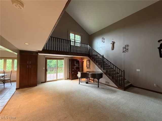 2484 Township Road 262, Bergholz, OH 43908 - living room with high vaulted ceiling, light carpet, and stairs