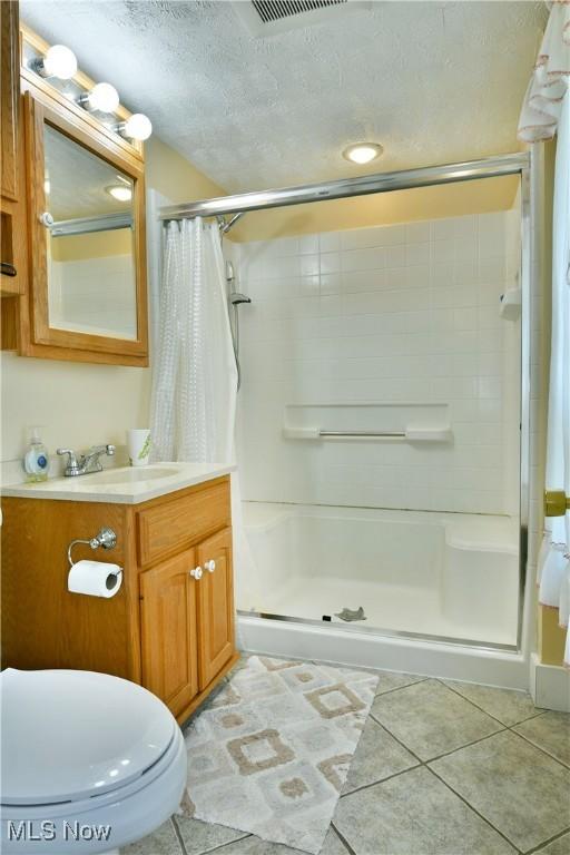 1774 Edgewood St NE, Warren, OH 44483 - full bath with a shower stall, tile patterned flooring, vanity, a textured ceiling, and recessed lighting