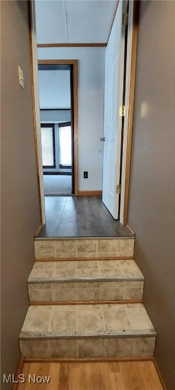 215 N 10th St, Cambridge, OH 43725 - stairway featuring wood finished floors and baseboards