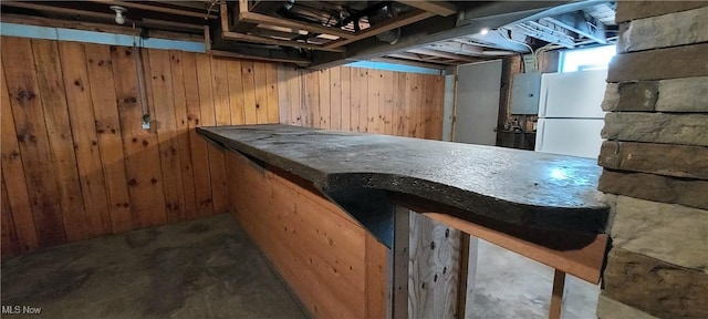 215 N 10th St, Cambridge, OH 43725 - bar area featuring wood walls and freestanding refrigerator