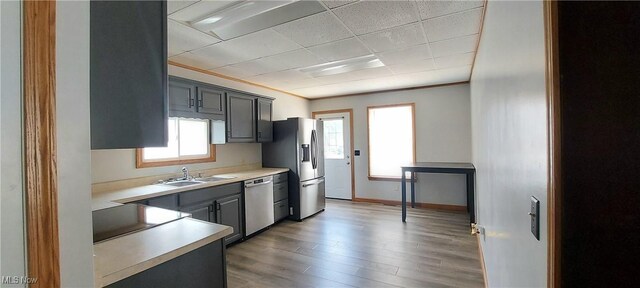 215 N 10th St, Cambridge, OH 43725 - kitchen with stainless steel appliances, light countertops, light wood-style floors, and gray cabinetry
