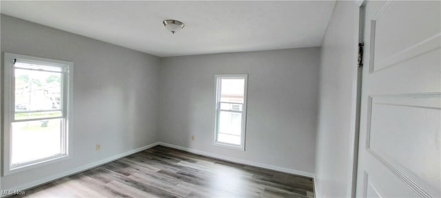 215 N 10th St, Cambridge, OH 43725 - spare room featuring healthy amount of natural light and wood finished floors