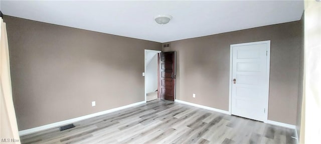 215 N 10th St, Cambridge, OH 43725 - spare room with light wood-style floors and baseboards