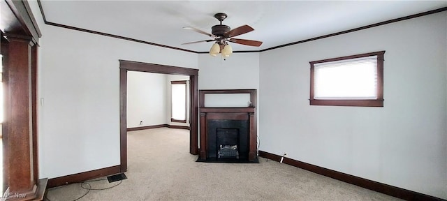 215 N 10th St, Cambridge, OH 43725 - empty room featuring healthy amount of natural light, crown molding, a ceiling fan, a fireplace, and light carpet