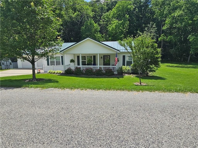 3925 N Wedgewood Dr, Mcconnelsville, OH 43756 - ranch-style home featuring covered porch, driveway, a front yard, and a metal roof