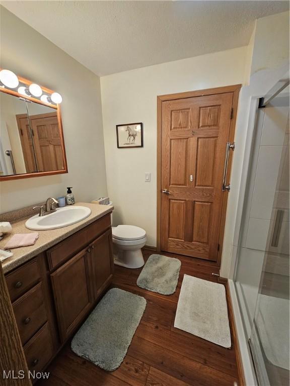 3925 N Wedgewood Dr, Mcconnelsville, OH 43756 - bathroom with vanity, hardwood / wood-style flooring, and a stall shower