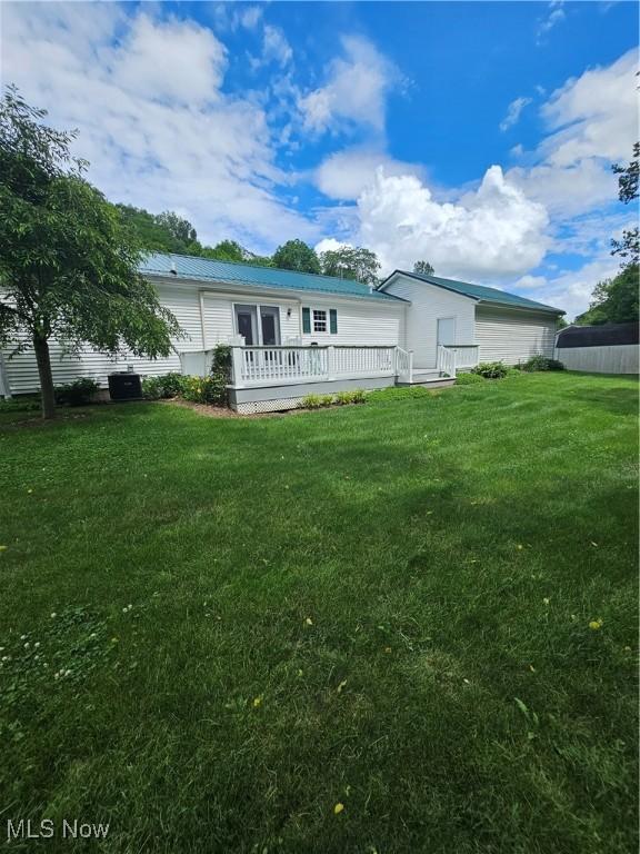 3925 N Wedgewood Dr, Mcconnelsville, OH 43756 - rear view of property featuring a wooden deck and a yard