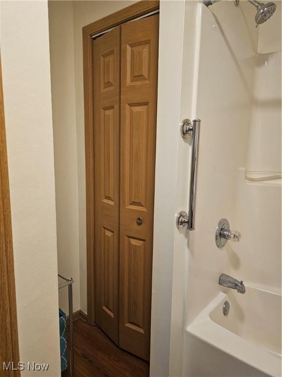 3925 N Wedgewood Dr, Mcconnelsville, OH 43756 - full bath with washtub / shower combination, a closet, and wood finished floors