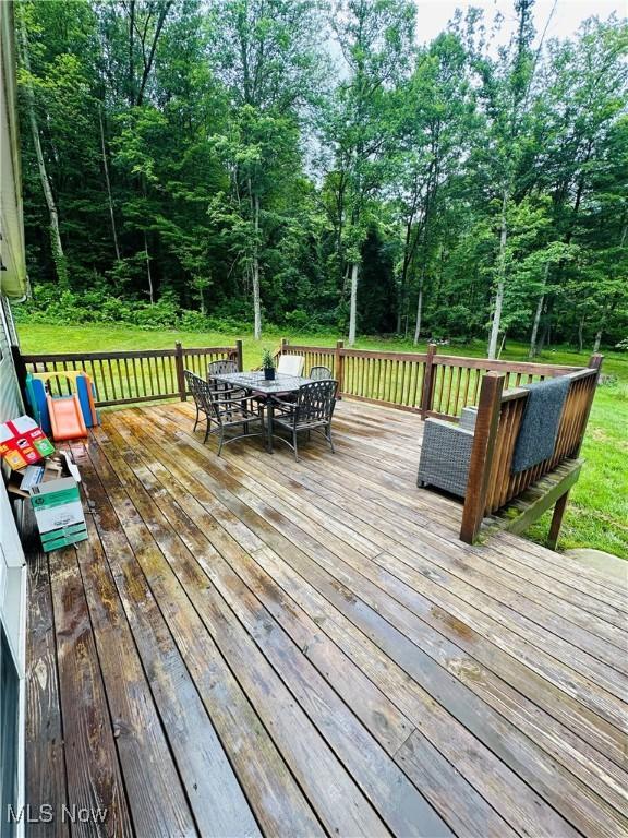 62063 Savage Rd, Cambridge, OH 43725 - wooden deck with outdoor dining space and a yard