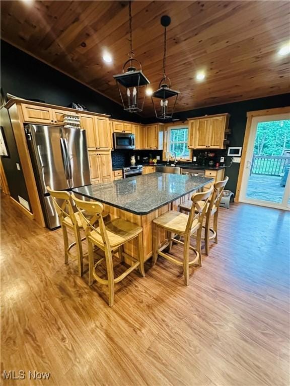 62063 Savage Rd, Cambridge, OH 43725 - kitchen featuring stainless steel appliances, wood ceiling, light wood-type flooring, a chandelier, and a breakfast bar
