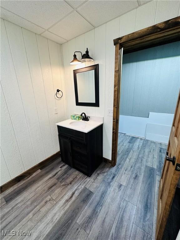 62063 Savage Rd, Cambridge, OH 43725 - bathroom featuring vanity, wood finished floors, and a paneled ceiling