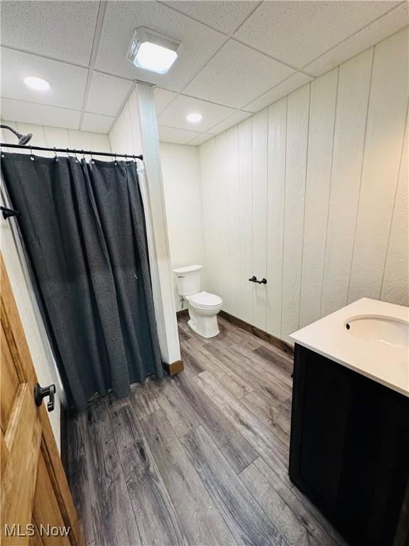 62063 Savage Rd, Cambridge, OH 43725 - bathroom with vanity, a drop ceiling, wood finished floors, and a shower with curtain