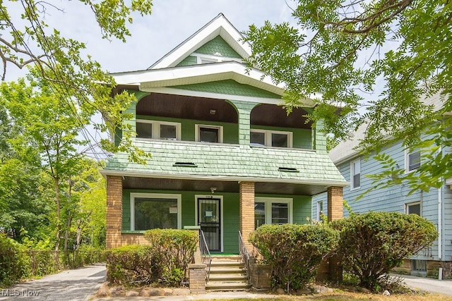 15517 Kipling Ave, Cleveland, OH 44110 - view of front facade with a balcony and a porch