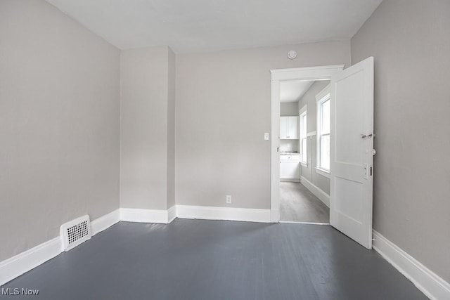 15517 Kipling Ave, Cleveland, OH 44110 - spare room featuring dark wood-type flooring and a smoke detector