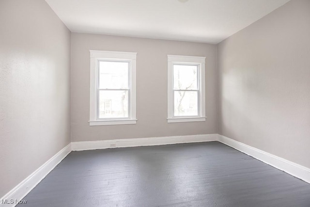 15517 Kipling Ave, Cleveland, OH 44110 - spare room with dark wood finished floors and baseboards