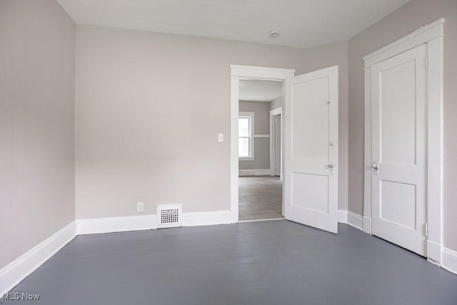 15517 Kipling Ave, Cleveland, OH 44110 - unfurnished bedroom featuring baseboards and finished concrete flooring