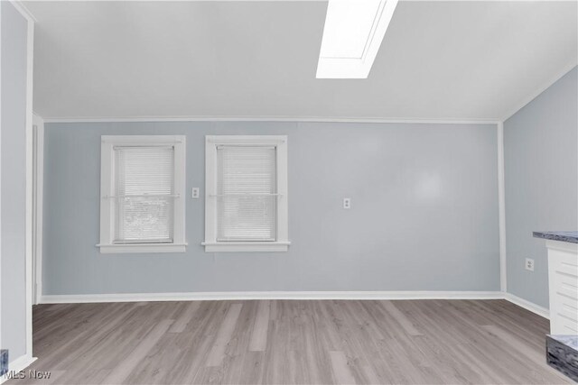 3009 Delmar Ave, Cleveland, OH 44109 - spare room featuring a skylight, wood finished floors, and crown molding