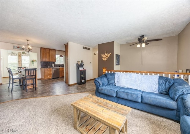 1902 26th Ave, Parkersburg, WV 26101 - living room with a chandelier, a ceiling fan, a textured ceiling, and dark colored carpet