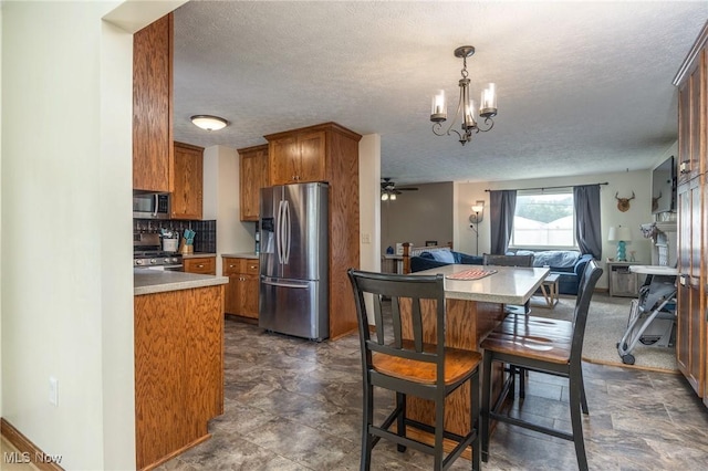 1902 26th Ave, Parkersburg, WV 26101 - dining room featuring a textured ceiling, a chandelier, and ceiling fan