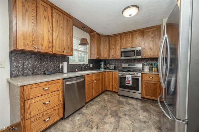 1902 26th Ave, Parkersburg, WV 26101 - kitchen featuring appliances with stainless steel finishes, brown cabinetry, decorative backsplash, and light countertops