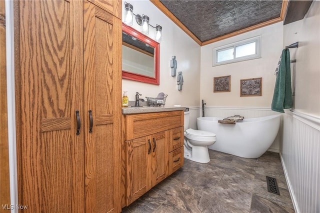 1902 26th Ave, Parkersburg, WV 26101 - bathroom with ornamental molding, vanity, a freestanding bath, and a wainscoted wall